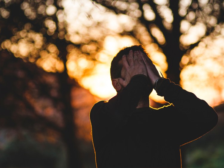 stressed man with hands over face