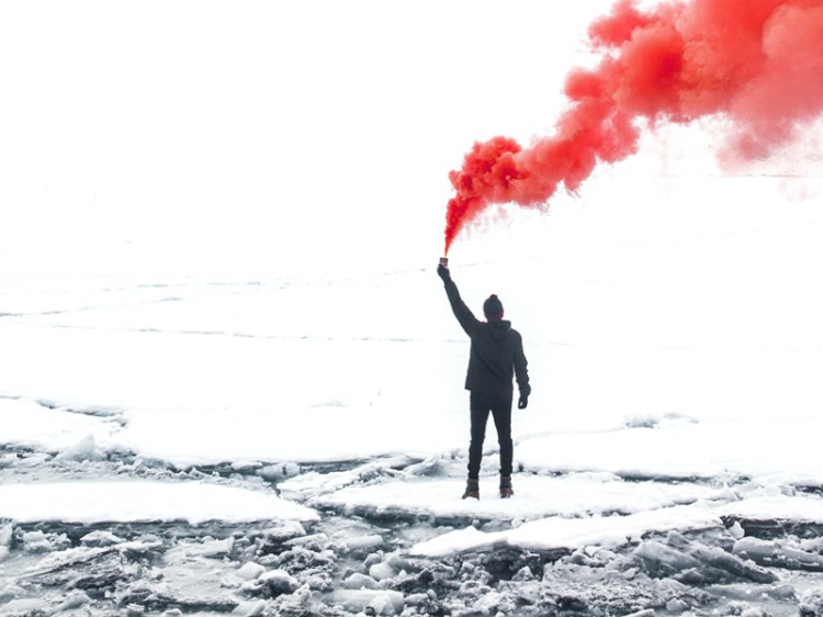 man-with-red-smoke-in-snow